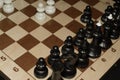 Chessboard under black chessmen as a skill backdrop Royalty Free Stock Photo