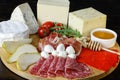 Chesse platte with different cheeses, meats on wooden board