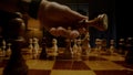 Chessman hand moves black king and captures white bishop