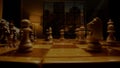 Chessman hand moves black knight on wooden chessboard