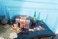 Chest, candles and a bottle on the stele.