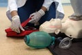 Chest compressions by a student on a simulation dummy during basic life support with an automatic external defibrillator.