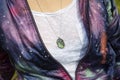 Chest detail in space jacket with labradorite pendant on silver chain Royalty Free Stock Photo