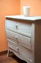 Chest of drawers with candle glass Royalty Free Stock Photo