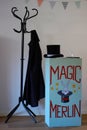 Magician stage setting. Chest of drawers with painting, stovepipe hat and coat