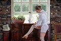 A dancer adjusting her stockings near the dresser Royalty Free Stock Photo