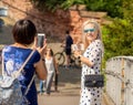 Chester UK August 2019 tourists on the queens gate bridge over the river Dee taking photographs with there mobile phones
