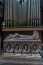 Vertical view of bishop`s tomb and church organ pipes inside the historic Chester Cathedral Royalty Free Stock Photo