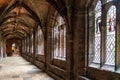 View of the cloister hallway in the courtyard of the historic Chester Cathedral with stained glass windows