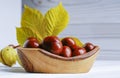 Chestnut fruit in oldwooden bowl on a white background Royalty Free Stock Photo