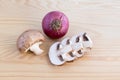 Chestnut mushrooms and red onion on wood Royalty Free Stock Photo