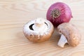 Chestnut mushroomsand red onion on wood Royalty Free Stock Photo