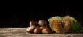 Chestnuts and chestnut bur on wooden table. Royalty Free Stock Photo