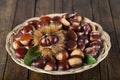 Chestnuts with leaves on a wooden background Royalty Free Stock Photo