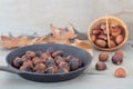 Chestnuts or maroni int on a black frying pan Royalty Free Stock Photo