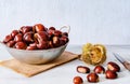 Chestnuts in a metallic basket on rustic wooden background Royalty Free Stock Photo