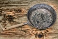 Pan for chestnuts, rusty and old on the tree wood