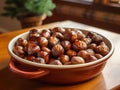 Chestnuts roasted on fire in a pan on table