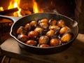 Chestnuts roasted on fire in a pan on table