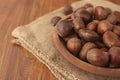 Chestnuts in a wooden bowl on a sackcloth.