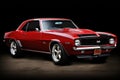 Chevrolet Camaro. A Red and Black Muscle Car Roars in the Shadows Royalty Free Stock Photo