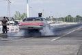 Chevrolet drag car making smoke show on the race track at the starting line