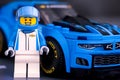 Chevrolet driver against Lego Chevrolet Camaro ZL1 race car by LEGO Speed Champions