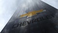 Chevrolet logo on a skyscraper facade reflecting clouds. Editorial 3D rendering