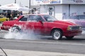 Chevrolet malibu making a burnout at the starting line