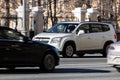 Chevrolet Orlando car is driving in the cityscape. Front side view of white compact MPV in motion Royalty Free Stock Photo