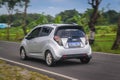 Chevrolet Spark hatchback driving on the rural road