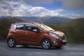 Chevrolet Spark orange car.