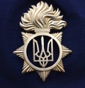 Chevron and the coat of arms Tryzub on a sleeve of a coat of Ukrainian policeman