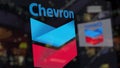 Chevron Corporation logo on the glass against blurred business center. Editorial 3D rendering