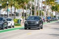 Chevy Suburban lux uber suv or lyft ride share vehicle cruising Miami Beach Ocean Drive