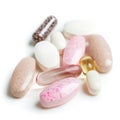 Chewable vitamins are displayed on a white surface. These vitamins come in different shapes and colors, ready for daily use to Royalty Free Stock Photo
