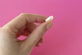 Chewed gum in a woman& x27;s hand on a pink background Royalty Free Stock Photo