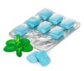 Chewing gum in blister with mint leaves close-up on a white background. Royalty Free Stock Photo