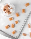 chewy caramels wrapped and unwrapped. Caramel candies in a small bowl Royalty Free Stock Photo