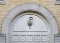 Chi Rho cross and crown above a doorway outside Christ the King Catholic Church in Dallas, Texas