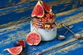 Chia milk pudding with granola and fresh sliced figs in the glass jar decorated with vintage spoons on the blue wooden table Royalty Free Stock Photo