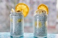 Chia pudding with banana in two glass jars on the blue wooden table. Chia smoothie with fresh fruits: banana, orange Royalty Free Stock Photo