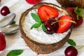 Chia pudding with fresh strawberry, cherry and mint in coconut bowl with spoons. healthy breakfast Royalty Free Stock Photo