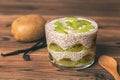 Chia pudding in glass cup made with kiwi fruit, decorated vanil