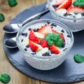 Chia seed pudding with strawberries, almond and chocolate cookie crumbs, on slate board, square format Royalty Free Stock Photo