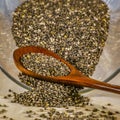 Chia seeds inside a glass jar with wooden spoon Royalty Free Stock Photo