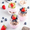 Chia seeds pudding with granola, blueberry and strawberry in glasses. Yogurt with chia seeds, berries, kiwi and muesli for healthy