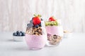Chia seeds pudding with granola, blueberry and strawberry in glasses. Yogurt with chia seeds, berries, kiwi and muesli for healthy