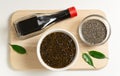 Chia seeds with soy sauce and nori seaweed on a wooden cutting board on a white plate. Vegan snack concept. Royalty Free Stock Photo