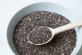 Chia seeds in a wooden spoon in a bowl on the table close-up. Royalty Free Stock Photo